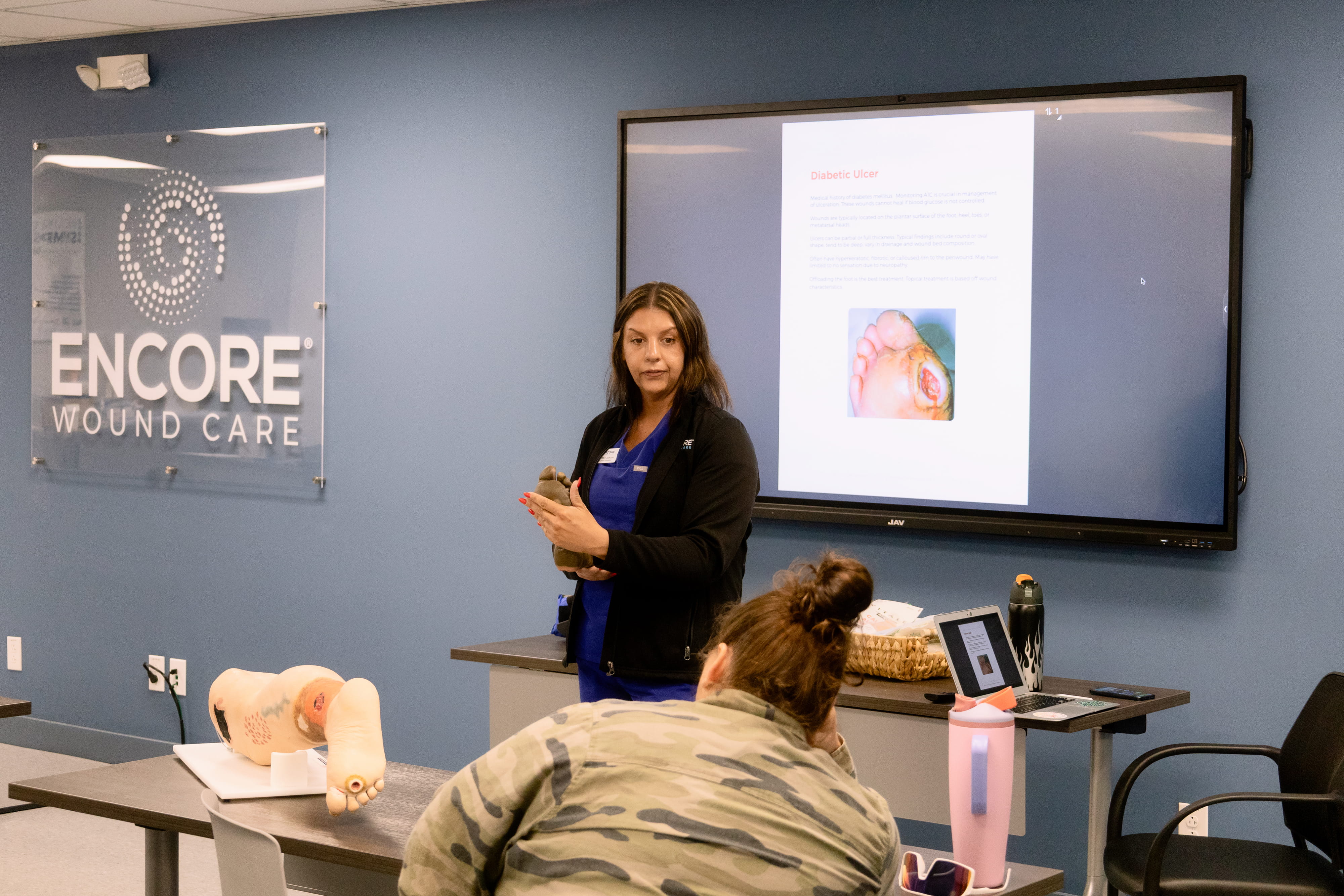 Instructor demonstrating wound care technique